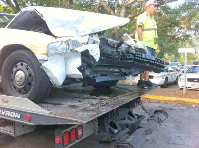 Damage to front of car after a crash. On tow truck.