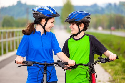 Kids (boy and girl) on bikes.