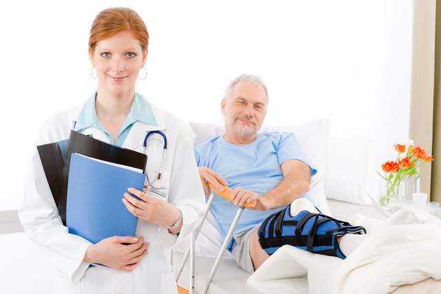 man with knee brace with doctor in hospital