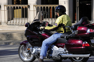 Man with helmet riding a motorcycle in the street