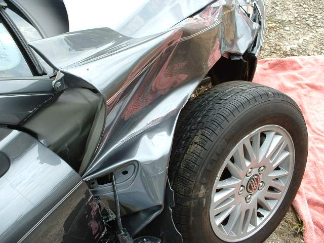 Front passenger side damage to car frame.