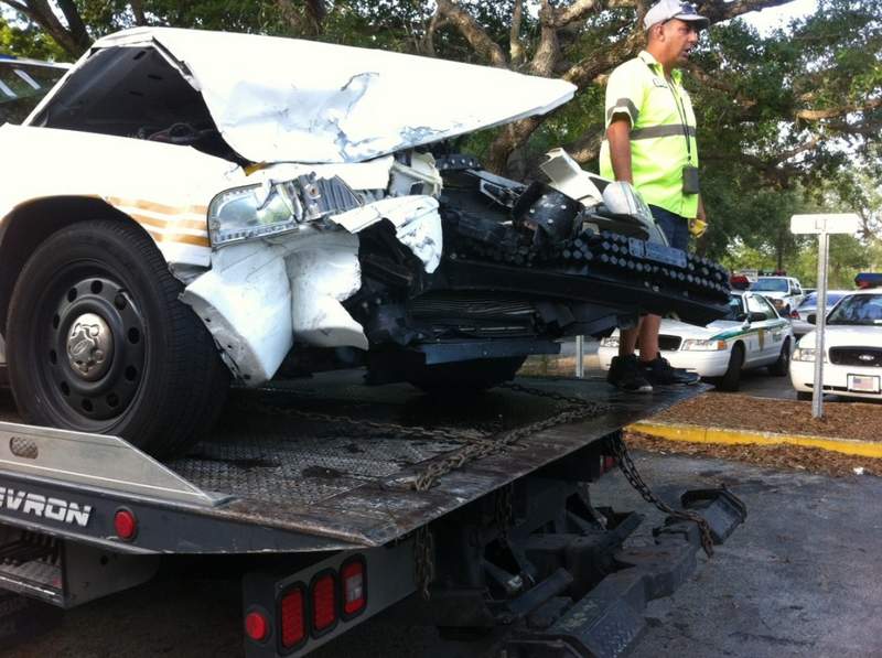 frontal car damage from t-bone impact; car on tow truck bed