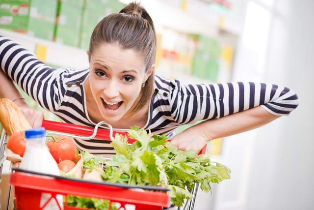 Lady pushing shopping cart.