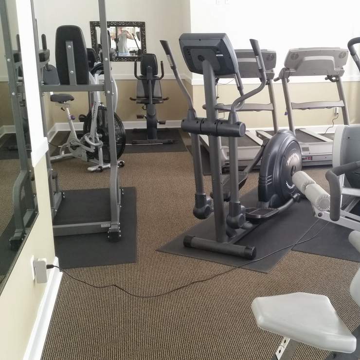 Power cord that is not secured to the floor in a condominium gym is a trip hazard. Pinecrest, Miami-Dade County, Florida.