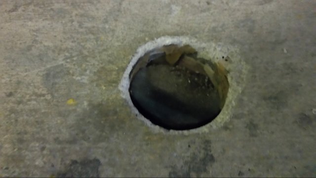 Uncovered hole in a condominium parking garage.