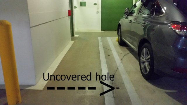 Uncovered hole in a condominium parking garage.