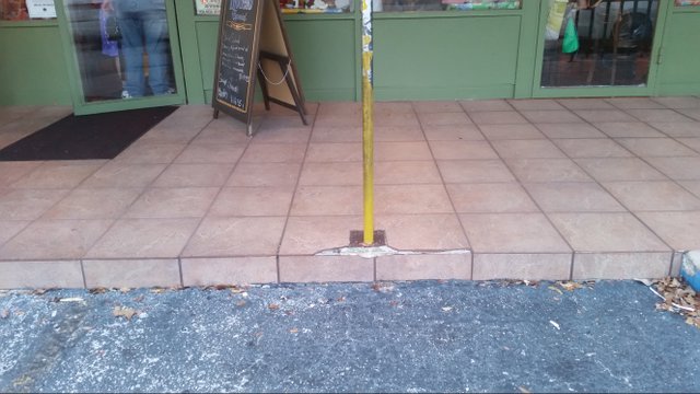 Broken tile outside of a restaurant in Pinecrest, Miami-Dade County, Florida