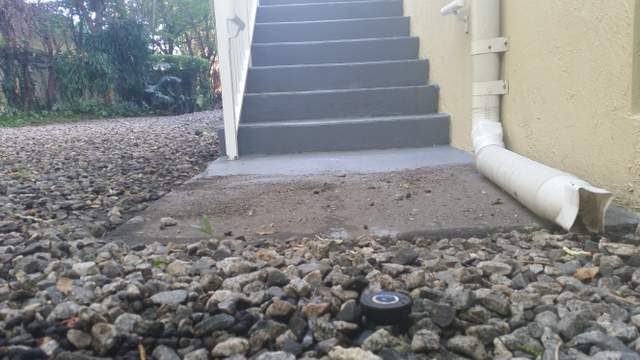  Picture of dirt on walkway on bottom of staircase.