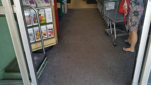 Carpet inside a supermarket entrance.