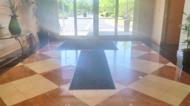 Two mats inside hotel entrance.