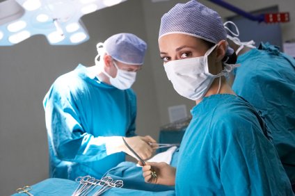 Doctors performing head injury surgery in operating room.