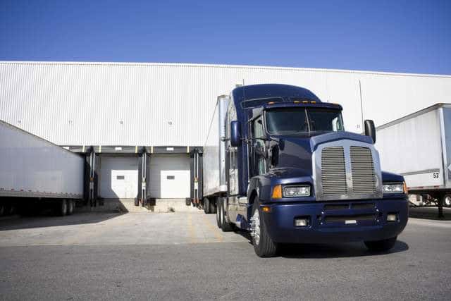 18 wheeler truck backed into loading dock at a warehouse 