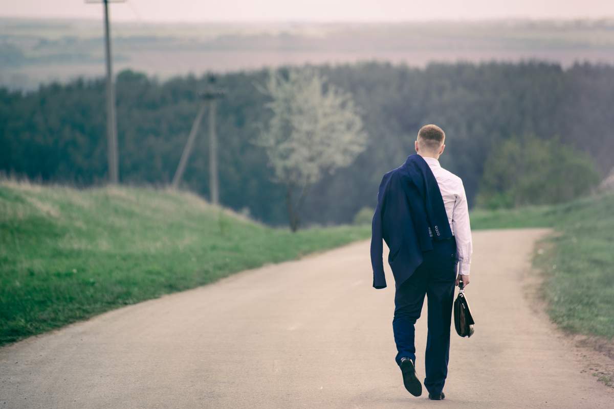 Pedestrian walking near edge of road