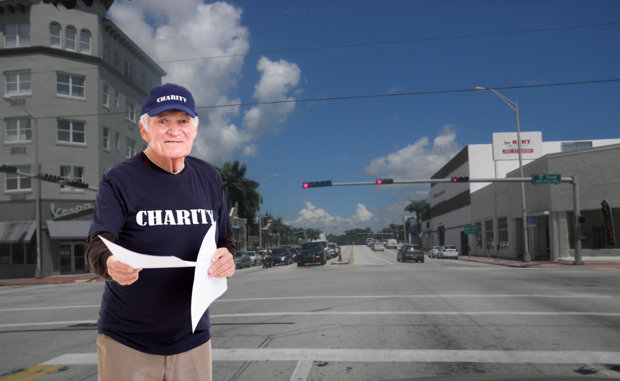 Man with charity shirt handing out flyers at intersection in Miami Beach, Florida