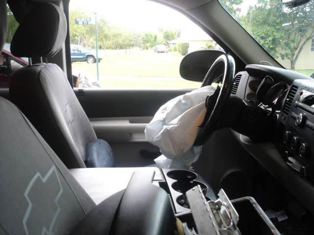Inside of pickup truck with driver side airbag deployed