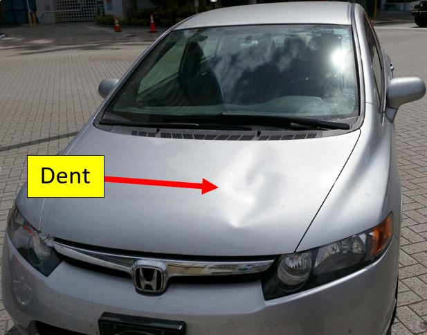 dent on hood of car from pedestrian landing on it after getting hit