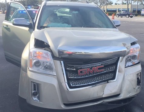 damage to front hood and fender of GMC SUV