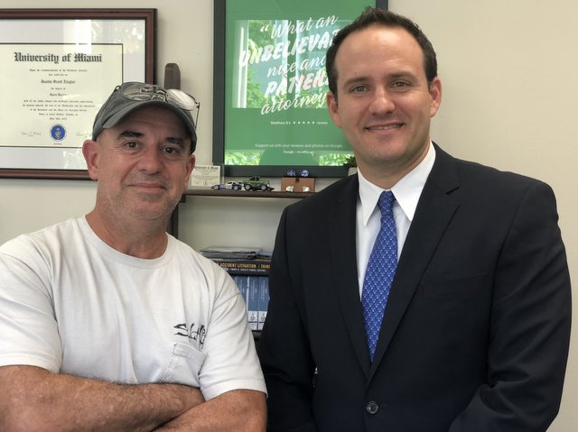 Miami injury lawyer Justin Ziegler with a car accident victim (client)