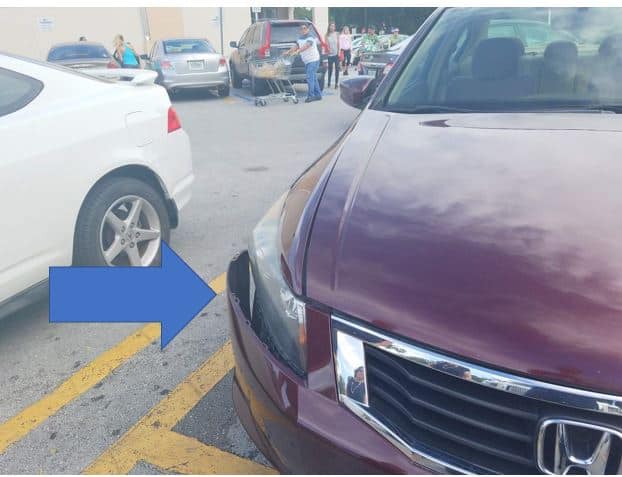 arrow pointing to car damage