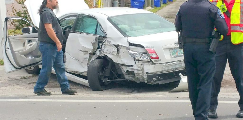 damage to rear and driver side of car.  car tire is blown and turned to the side.