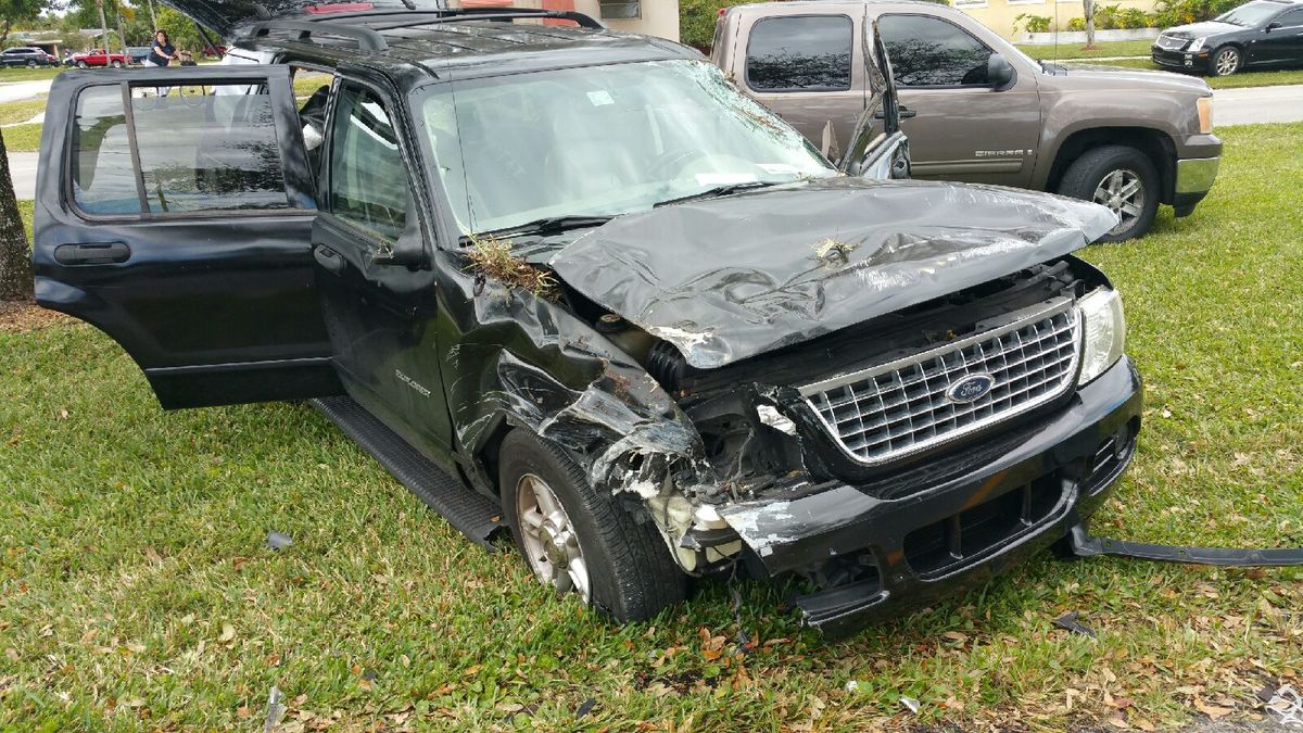 damage to front (hood, fender, lights) of SUV after a rollover accident 