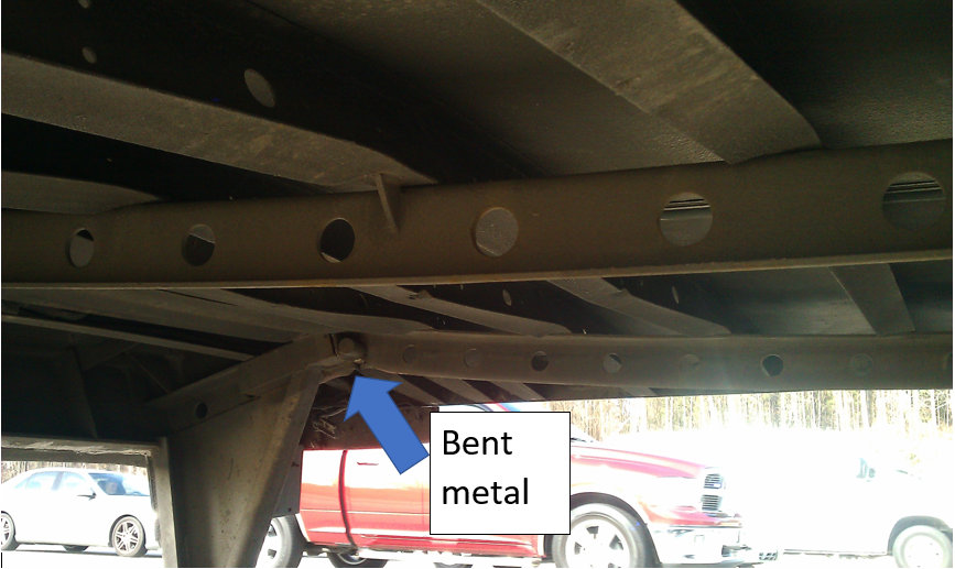 bent metal under the semi truck