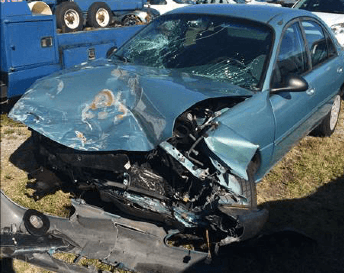 damage to front of car (bent hood and fender ripped off)