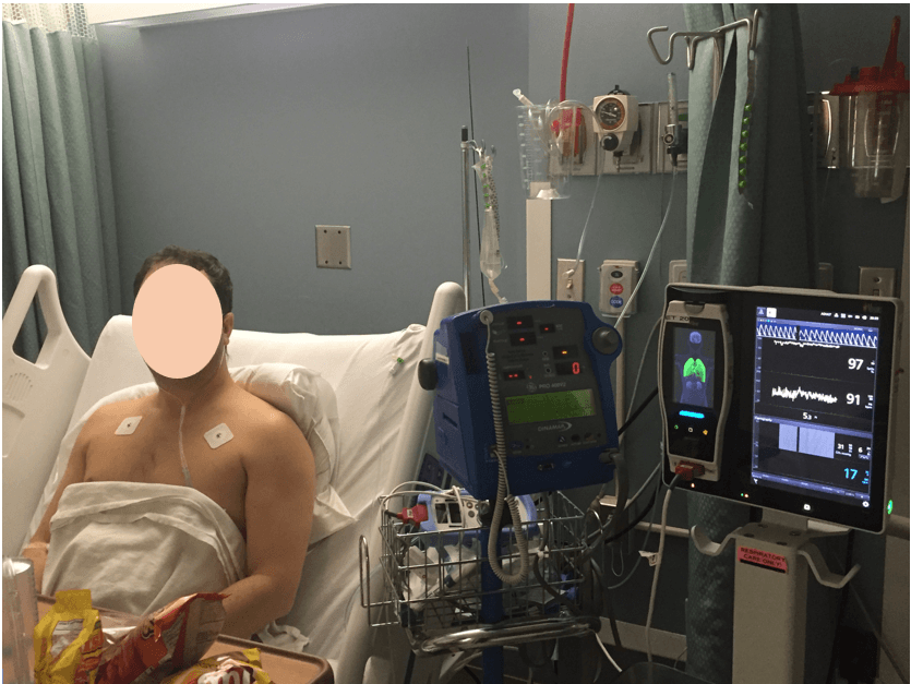 patient in hospital bed with leads on his chest