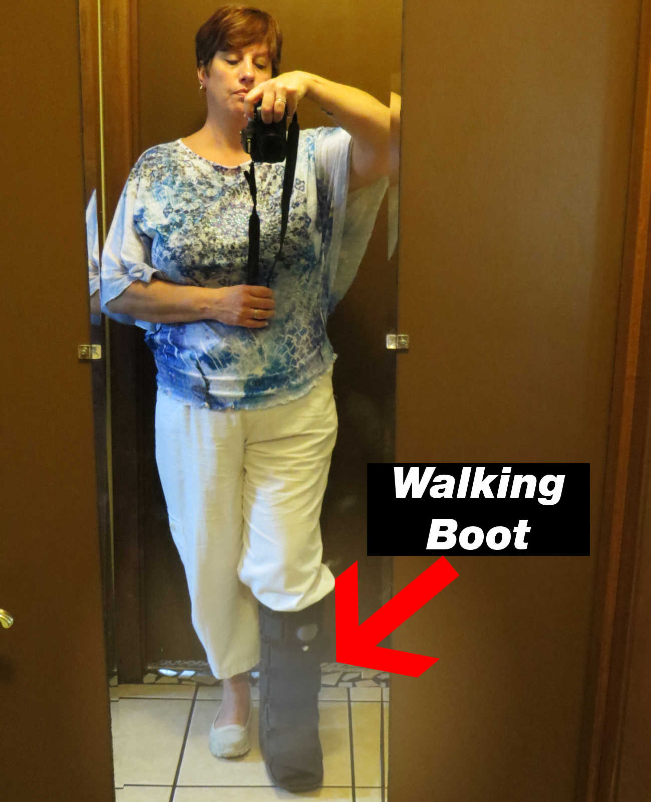 woman with a broken ankle wearing a walking boot 