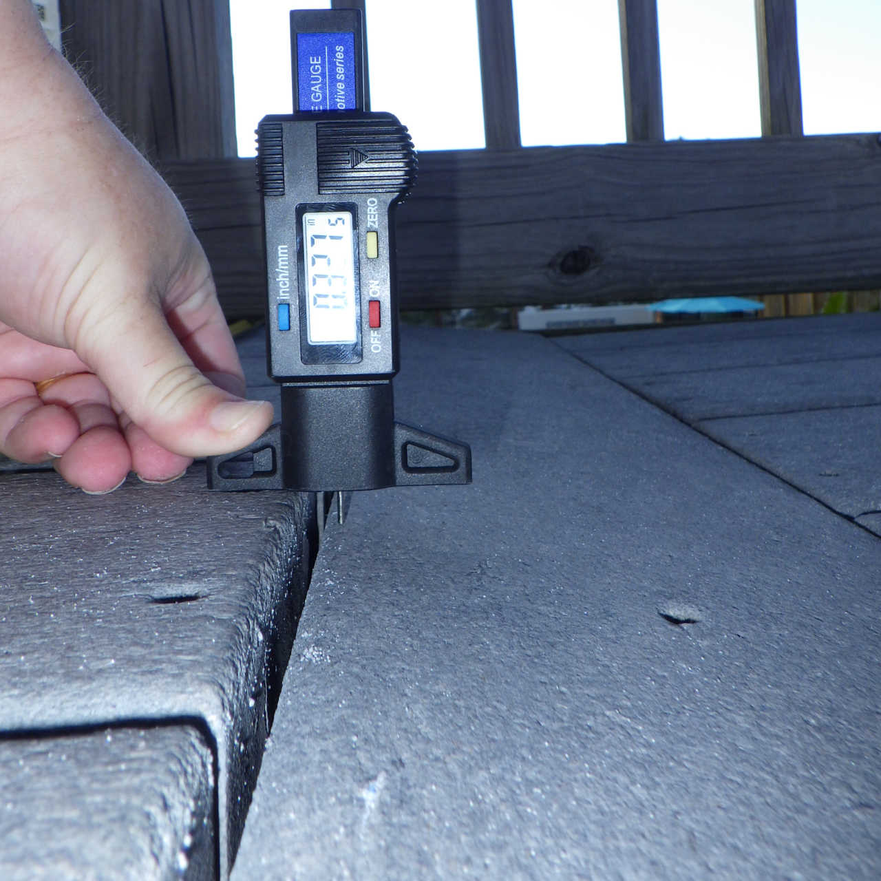 expert engineer photo of measurement using digital device showing change in elevation if .33 inches on a boardwalk