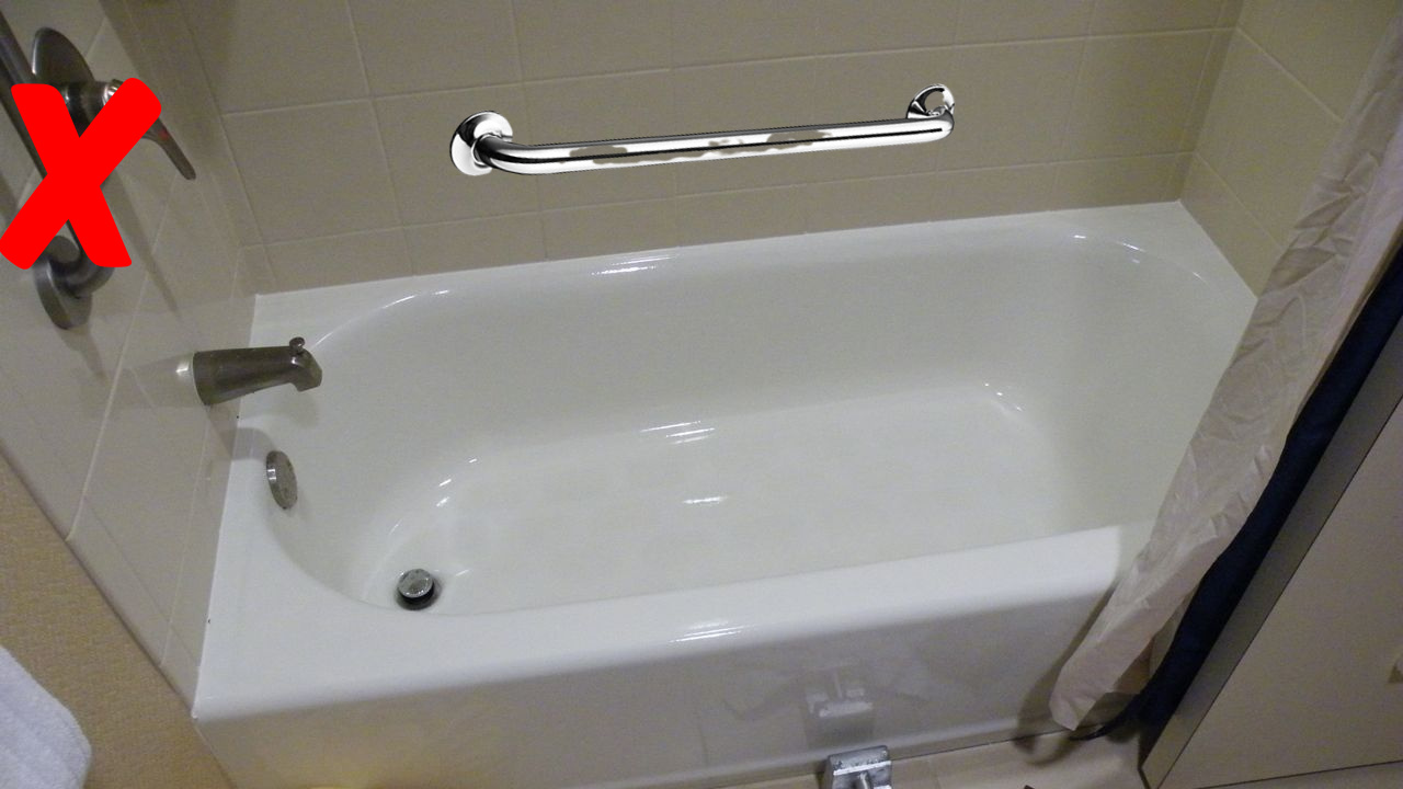 hotel bathtub with possible improper placement of grab bar on the furthermost wall from entrance